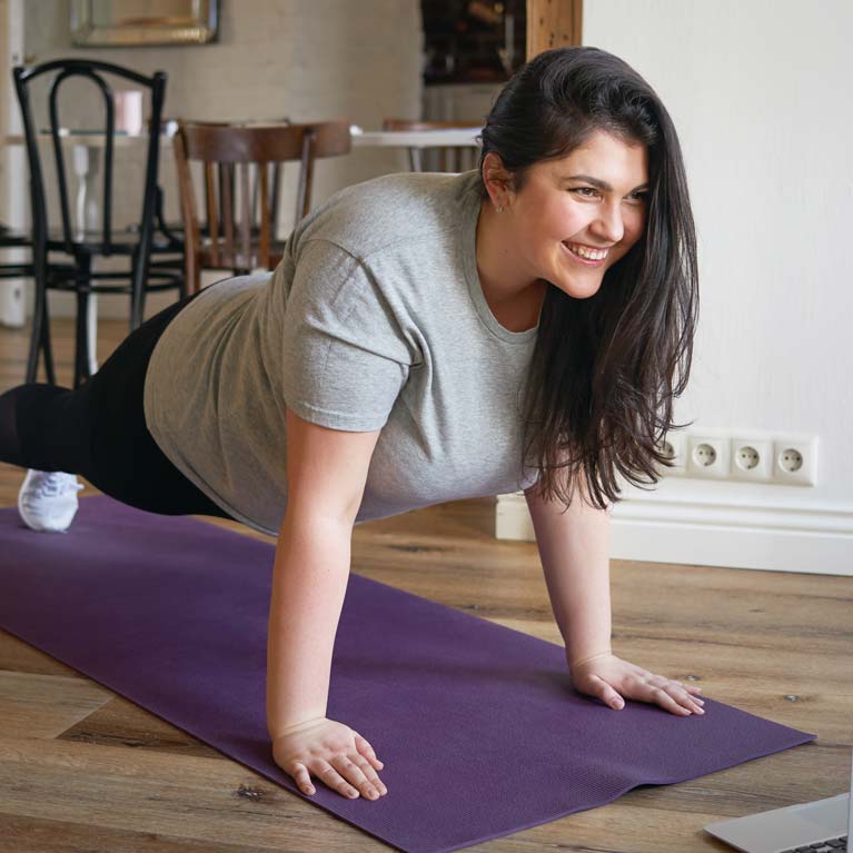 Woman doing Pilates Zoom class at home