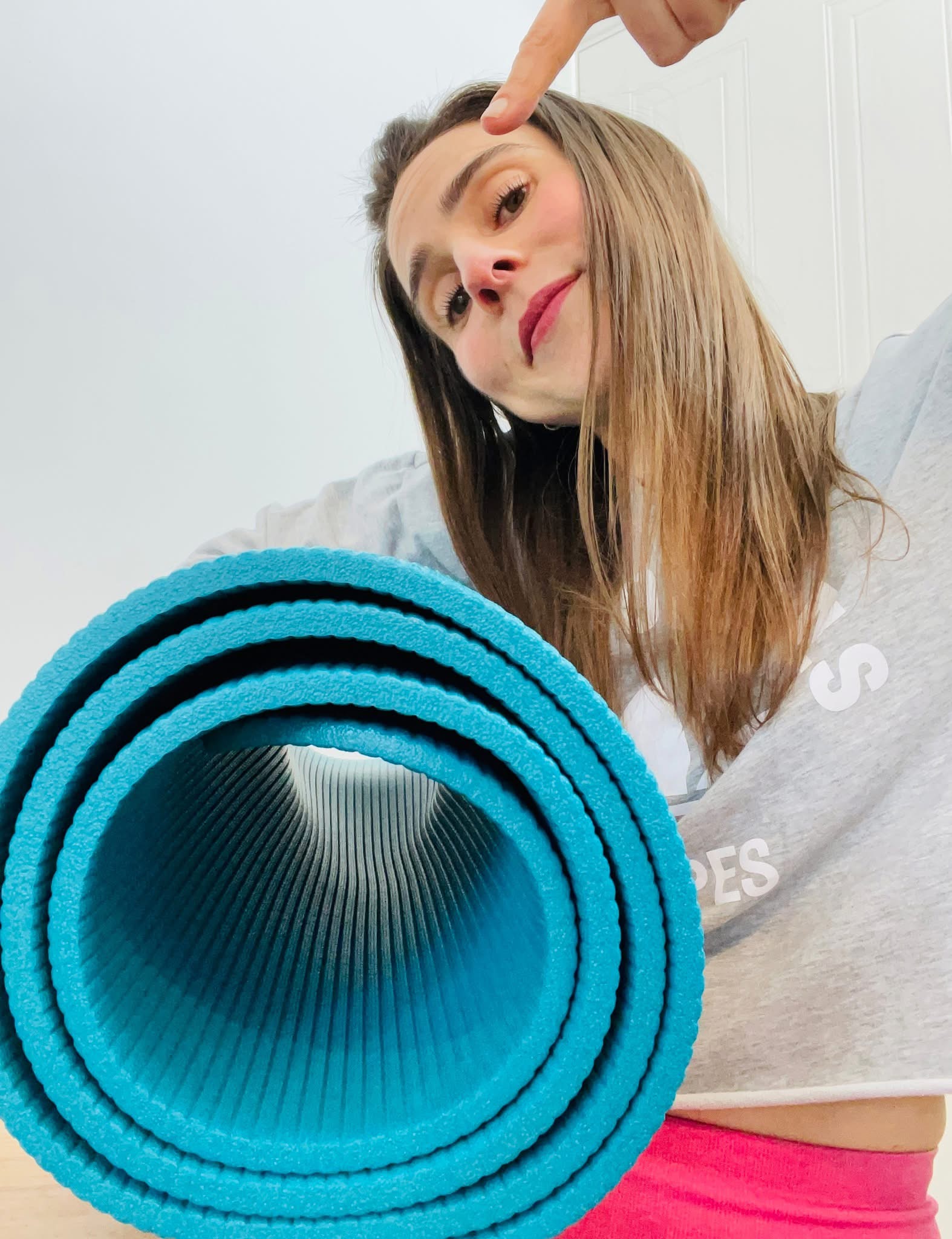 Kathryn Knights, Pilates instructor for beginners, wearing sportswear and standing with hands on hips
